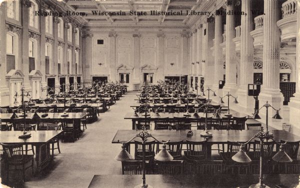 Photographic postcard view of the Reading Room at the State Historical Library, now the headquarters building of the Wisconsin Historical Society. The text at the top reads "Reading Room, Wisconsin State Historical Library, Madison, Wis."