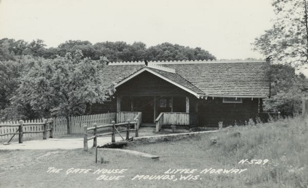 Photographic postcard of the Gate House at Little Norway. Text below reads "The Gate House, Little Norway, Blue Mounds, Wisconsin."