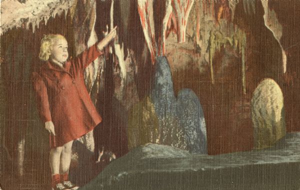 Colorized postcard of a girl pointing to a feature in the Gem Room, North Cave, opened in 1946, at the Cave of the Mounds.