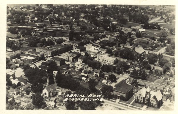 Photographic postcard of an aerial view of town. Text below reads: "Aerial View — Boscobel, Wis."