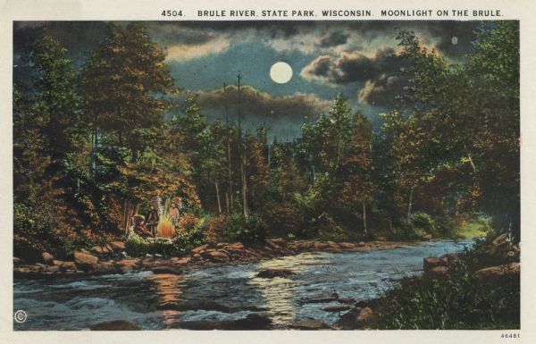 Colorized postcard view of the Brule River flowing through the forest by moonlight. Some trees show autumn color. There is a campfire on the shore with three Native Americans wearing feather headdresses gethered around it. Caption reads: "Brule River, State Park, Wisconsin. Moonlight on the Brule."