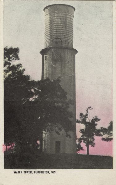 Colorized postcard of the water tower, also known as "Stand Pipe." Caption reads: "Water Tower, Burlington, Wis."