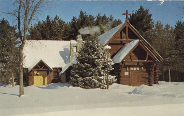 Color postcard of Trinity Lutheran Church. It is a log chapel, built of native timber, and designed to fit the Northwoods area.