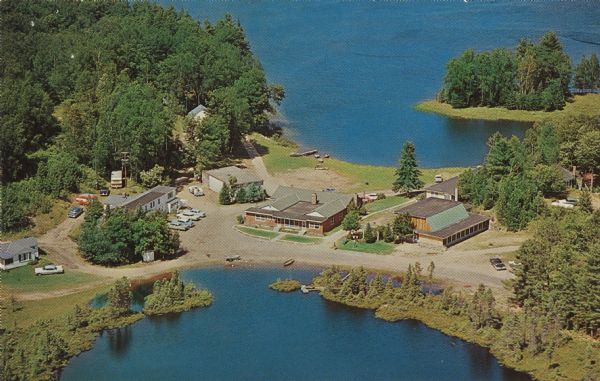 Color postcard of an aerial view of the Lakewoods Family Resort on Lake Namekagon. All modern housekeeping cottages with an indoor heated swimming pool.