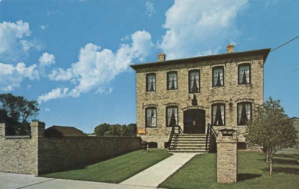 Color photographic postcard of the exterior to the Von Stiehl Winery building. The Italianate structure was built in 1868 on what is now called South Water Street by mason Thomas Bacon. The brewery and warehouse was later used as the site to manufacture fly nets. The building fell into disrepair in the 1960s, but was later restored and turned into a winery. Today, the owners produce wine made out of Door County cherries.