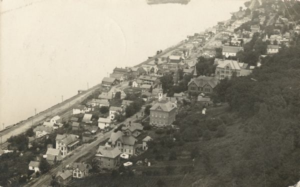 Photographic postcard of an aerial view of town looking North. The Mississippi River is on the left.