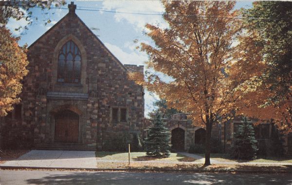Color postcard of St. Hyacinth Catholic Church. View of the main facade is slightly obscured by golden-leaved trees.