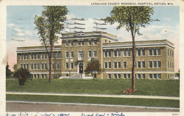 Color postcard of the front entrance to the hospital. Caption reads: "Langlade County Memorial Hospital, Antigo, Wis."