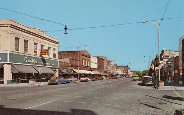 Color postcard of the downtown area on 5th Avenue facing east.