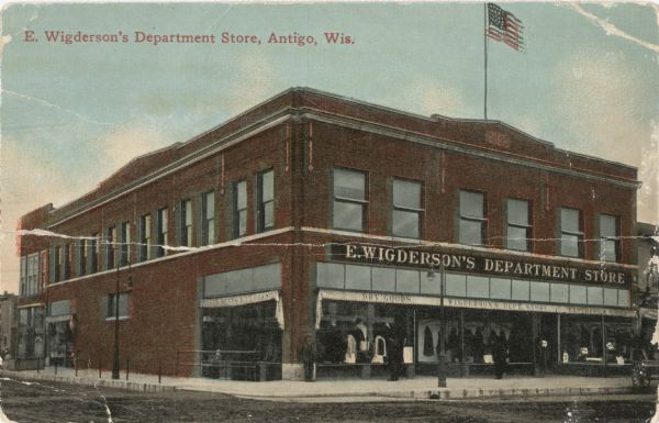 View across street toward the front of E. Wigderson's Department Store located on the southwest corner of 5th Avenue and Superior Street. Caption reads: "E. Wigderson's Department Store, Antigo, Wis."