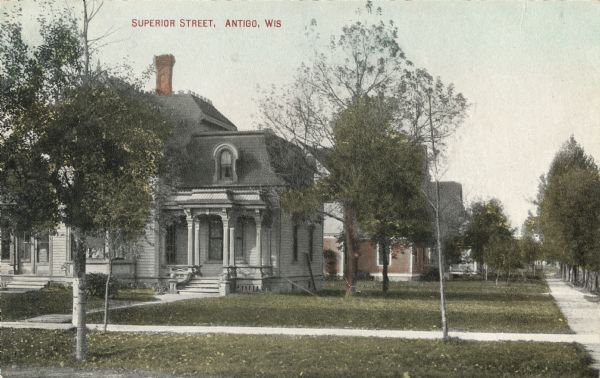 View of residential houses on Superior Street. Caption reads: "Superior Street, Antigo, Wis."
