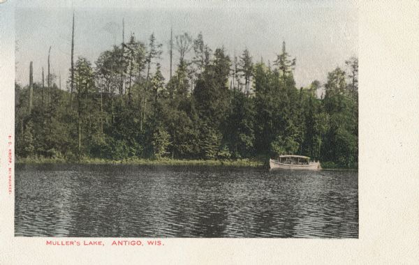 Colorized postcard view of a covered boat at the shoreline of Muller's Lake. Caption reads: "Muller's Lake, Antigo, Wis."