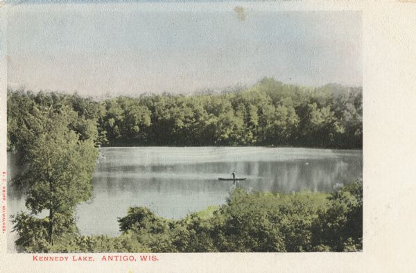 Color view from hill toward a lone boater on Kennedy Lake. Caption reads: "Kennedy Lake, Antigo, Wis."