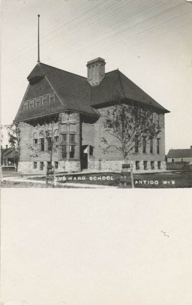 Exterior view of the school, a brick two-story building. Caption reads: "2nd Ward School, Antigo, Wis."