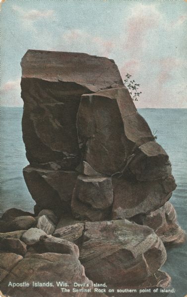 Postcard of the Sentinel Rock geological formation. Caption reads: "Apostle Islands, Wis. Devil's Island, The Sentinel Rock on southern point of island."
