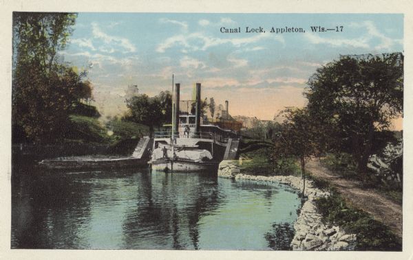 Colorized postcard of a steamboat passing through the canal lock along the Fox River. Caption reads: "Canal Lock, Appleton, Wis."