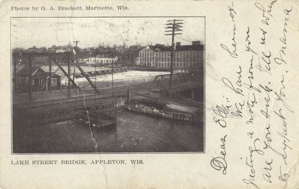Elevated view of Lake Street bridge and nearby locks along the Fox River. Caption reads: "Lake Street Bridge, Appleton, Wis."