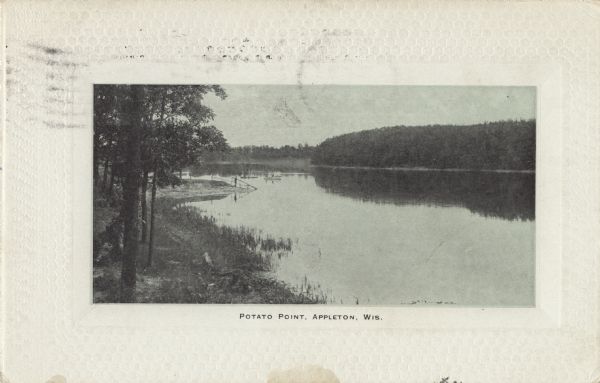 View of Potato Point. Trees line the shoreline of the Fox River. Boaters and fishermen are in the background. Caption reads: "Potato Point, Appleton, Wis."