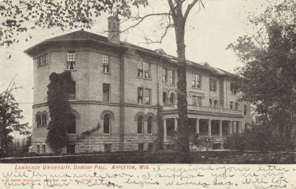 Exterior of the three-story Ormsby Hall residence hall on the Lawrence University campus. View of the front facade and side of the building surrounded by trees. Caption reads: "Lawrence University, Ormsby Hall, Appleton, Wis."