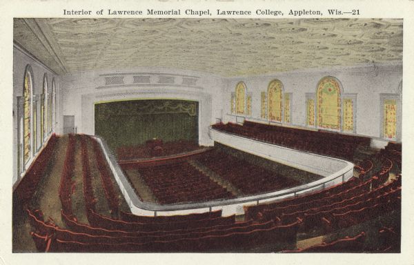 Elevated view of the interior seating and stage within Memorial Chapel on the campus of Lawrence University. Caption reads: "Interior of Lawrence Memorial Chapel, Lawrence College, Appleton, Wis."