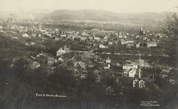 Aerial view of the downtown area, including a bridge spanning the Trempealeau River. Caption reads: "View of Arcadia, Wisconsin."