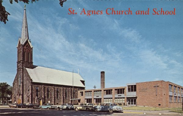 Exterior view of St. Agnes Church, on the left, and school, on the right. Cars line the street along Lake Shore Drive in front of the buildings.