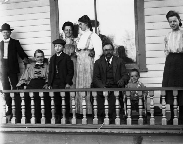 Family of Frank Wilson on the porch of their home.