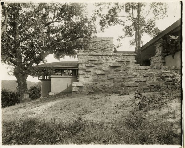 Taliesin I north elevation of the loggia terrace. The living room chimney and windows are in the background. The terrace walls are made of rubble masonry.