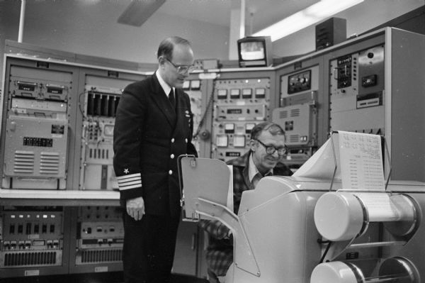 Captain Charles Biele and an unidentified staffer in the Navy facility at Clam Lake known as Project ELF.