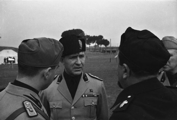 Fascist leader Dino Alfieri (facing the camera), Minister of Popular Culture in Italy.