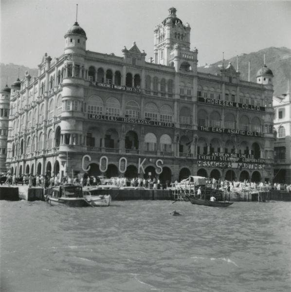 The large, ornamental office building of Thomas Cook and Sons on the waterfront in Hong Kong. The firm was one of the oldest and largest travel companies in the world.