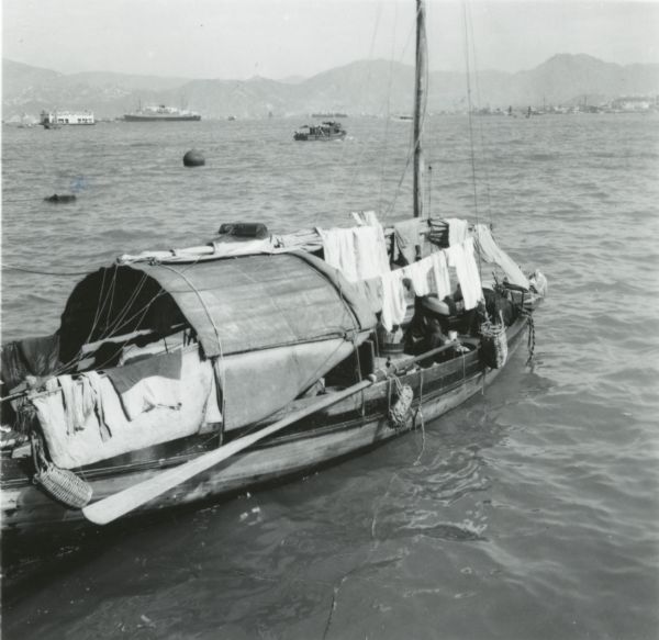 A sampan boat in Hong Kong harbor. Perhaps what caught the photographer's eye was the laundry on the boat hanging out to dry.