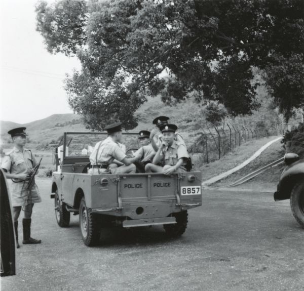 Hong Kong police with jeep who followed journalist Cecil Brown as he traveled along the border with Communist China.