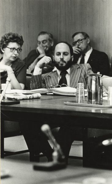 View from across room of John A. Lavine, a member of the University of Wisconsin Board of Regents, during a board meeting. Lavine, a newspaper publisher from Chippewa Falls, was initially appointed to the Board of Regents of the States Universities and, after merger, to the Board of Regents of the University System by Governor Patrick J. Lucey.