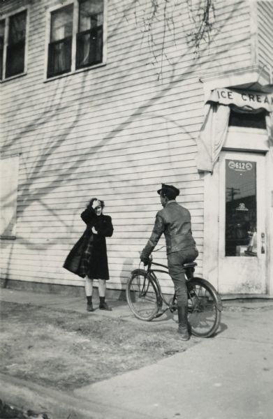 Lewis Arms sits on a bicycle in front of Jim White's Grocery in the Greenbush neighborhood. With him is Eldrie Berry, daughter of John and Pearl Berry, and sister of Helen Berry.