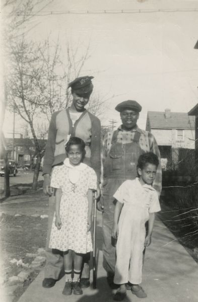 Lewis Arms poses with his sister and other children on Easter Day. Front from left to right are Nedra Arms (sister) and John Hall. From left to right behind them are Lewis Arms and his cousin Chester Elvord.