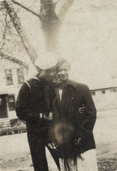 Lewis Arms, in his Navy uniform, hugs his mother Mamie (Arms) Hall.