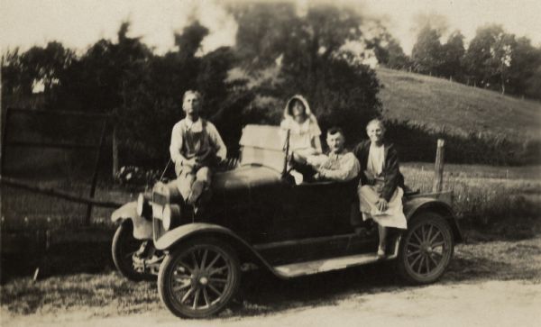 The Nofsinger family poses with their automobile, a Model T Ford.