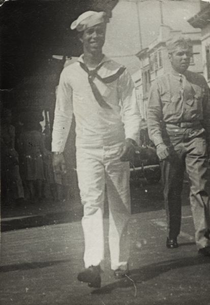 Lewis Arms marches in a military parade in downtown Honolulu. He is wearing his Navy uniform.