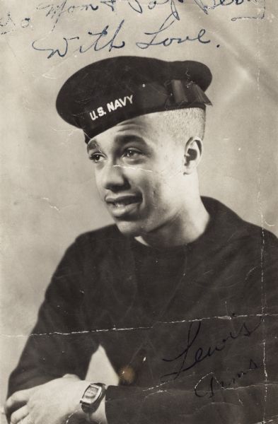 A portrait of Lewis Arms at the age of 17 wearing his Navy uniform. There is an inscription that reads, "To Mom & Pop Berry with Love," referring to his neighbors the Berrys. He is wearing a wristband that contains a small photograph (possibly of his mother).