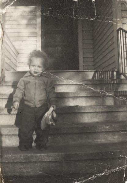 Lewis Arms, Jr. at 18 months old, standing on porch steps. On the back of the photograph is written "The Best Son in this Whole World".