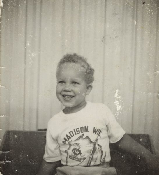 Lewis "Lewie" Arms, Jr. poses wearing a Madison, Wisconsin t-shirt.