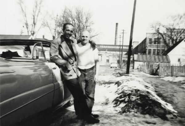 Lewis Arms leans against a car with his arm around his family friend and neighbor John Berry, who he called "Pa Berry".