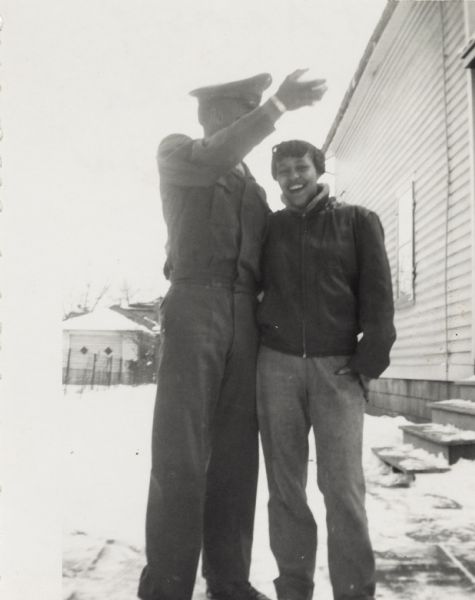Lewis Arms, who is wearing his Marine Corps uniform, poses outdoors with his sister Nedra.