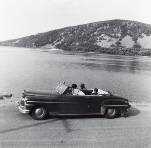 Lewis, LuRay, Nellie and Bernard Arms arrive at Devil's Lake in a maroon DeSoto convertible automobile. This was the day after Lewis and LuRay's wedding.