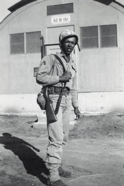 Lewis Arms in his Marine Corps uniform, with rifle and canteen, probably in Korea.