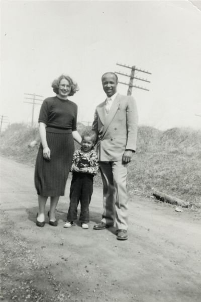 Lewis Arms poses outdoors with his wife, Elinora, and son, Lewis Arms, Jr.