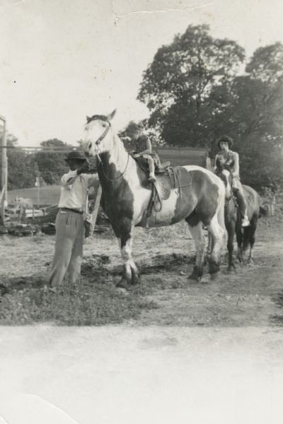 Bernard Arms (left) holds Lewis Arms's favorite horse Apache, upon whom Rita Arms (Witter) is seated. Behind them LuRay Arms sits on another horse holding Mamie Arms.