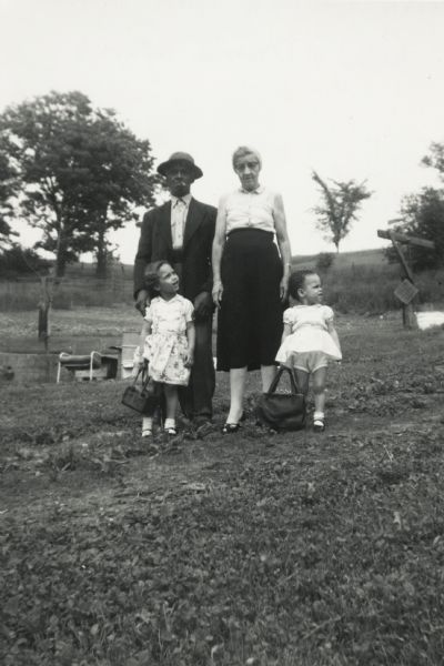 Bernard and Nellie Arms stand with (left to right, front) Rita and Mamie Arms, daughters of Lewis Arms.
