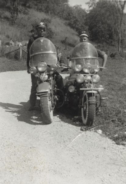 Lewis Arms (left) and Charlie Caldwell pose on their Harley-Davidson motorcycles.